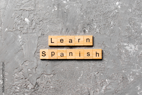 learn spanish word written on wood block. learn spanish text on table, concept