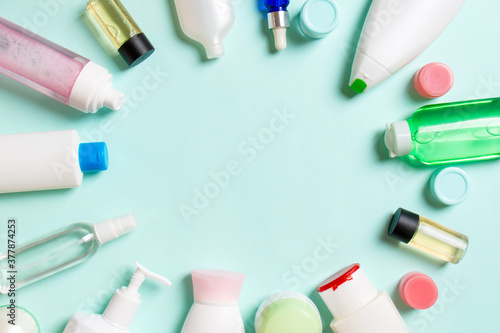 Frame of plastic bodycare bottle Flat lay composition with cosmetic products on colored background empty space for you design. Set of White Cosmetic containers, top view with copy space