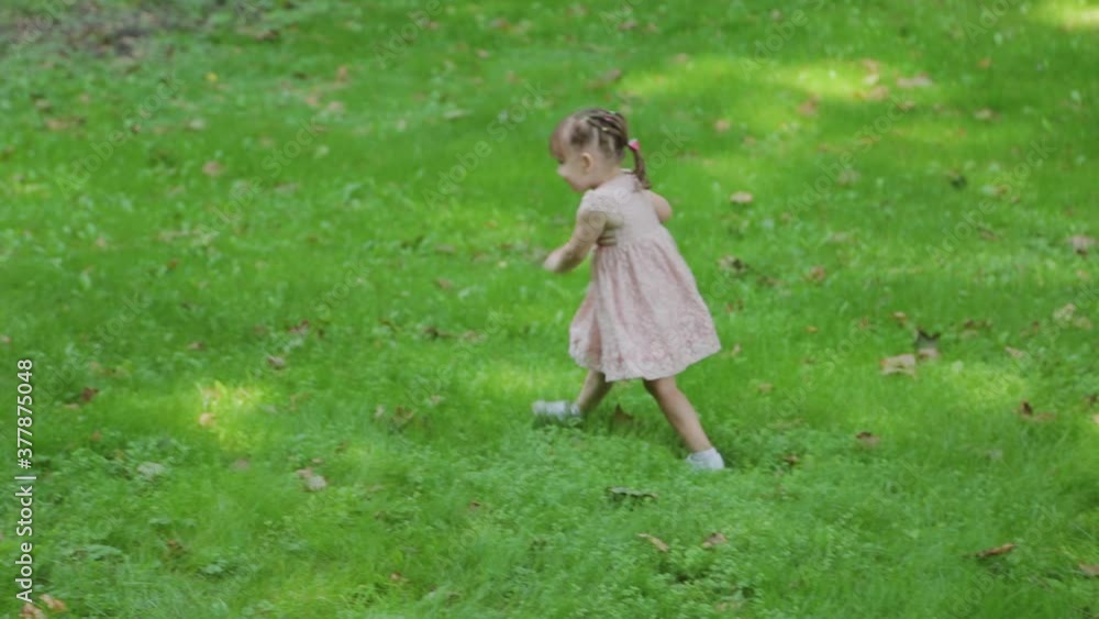 Young mother and little daughter are having fun in the park in sunny weather. Young mother and little daughter are having fun in the park in sunny weather.