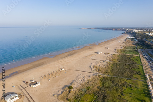 Los Bateles beach seen from a birds view on a quiet summer morning. Beautiful atlantic beach in Cadiz