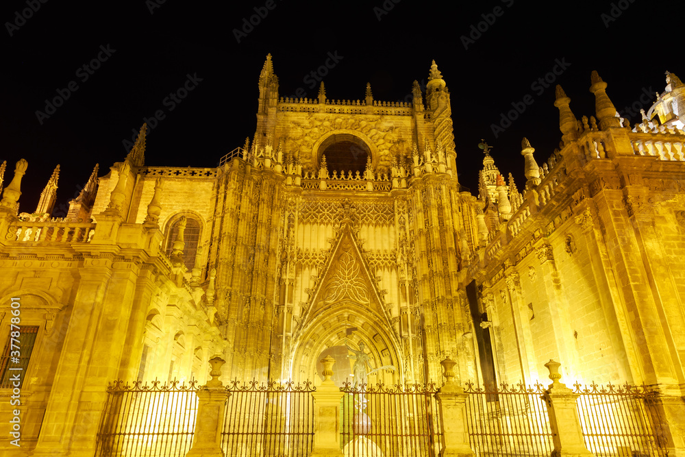 Seville Cathedral at night. Tourist attractions of Seville, Andalusia, Spain. Cathedral of Saint Mary of the See, a Roman Catholic and the largest Gothic church, is a UNESCO Heritage Site.