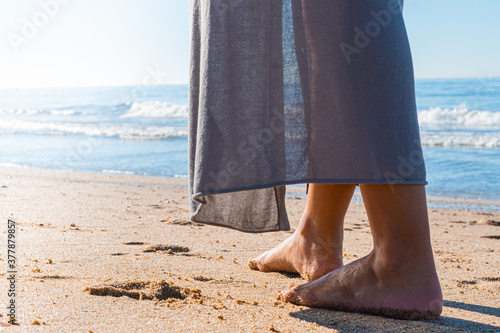 Beach travel - woman walking on sand beach closeup