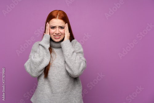 Redhead teenager girl over isolated purple background unhappy and frustrated with something. Negative facial expression