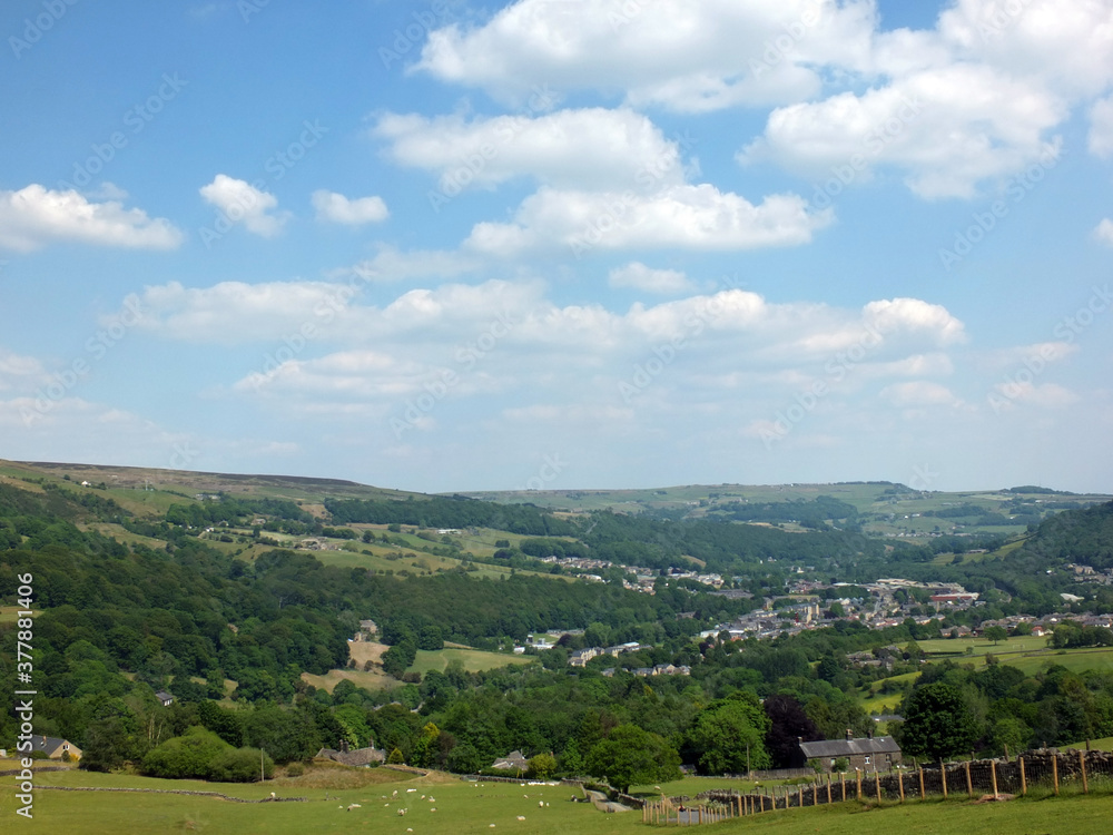 Fototapeta premium scenic view of the town of mytholmroyd surrounded by woods and fields in the calder valley west yorkshire