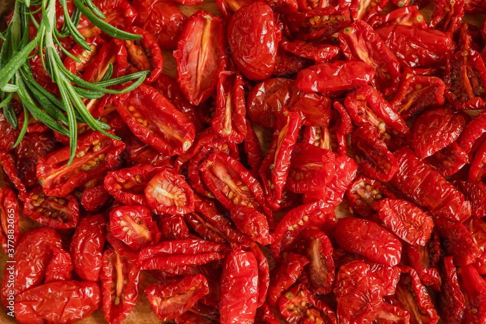 Homemade sun-Dried tomatoes with fresh rosemary. The view from the top. Print for kitchen