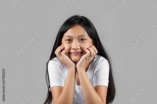 Asian girl studio portrait on gray background