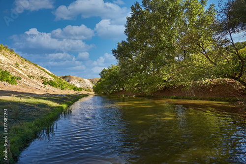 Beautiful river, a lot of greenery and trees, a beautiful reflection in the water.