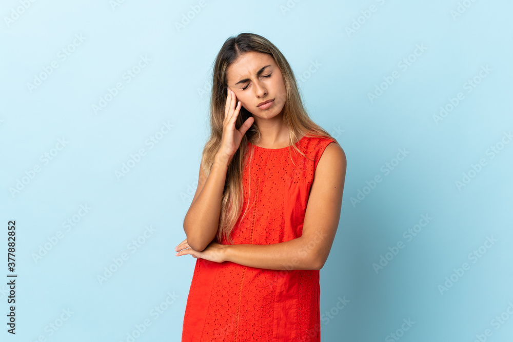 Young hispanic woman over isolated blue background with headache Young hispanic woman over isolated blue background with headache