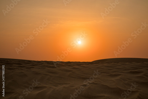 View of windy sand dunes deep in desert of Abu Dhabi - United Arab Emirates. Windy day in desert  desert safari.