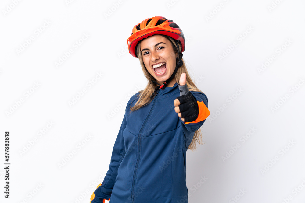 Young hispanic cyclist woman isolated on white background with thumbs up because something good has happened