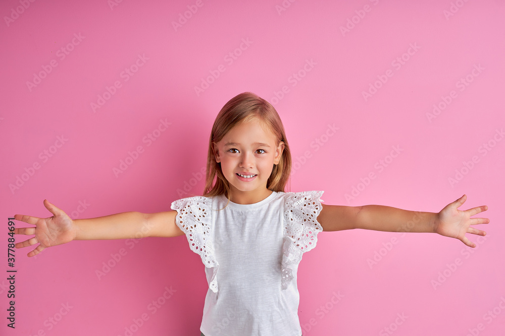 little caucasian girl want to hug everyone, spread arms at camera, isolated over pink background little caucasian girl want to hug everyone, spread arms at camera, isolated over pink background