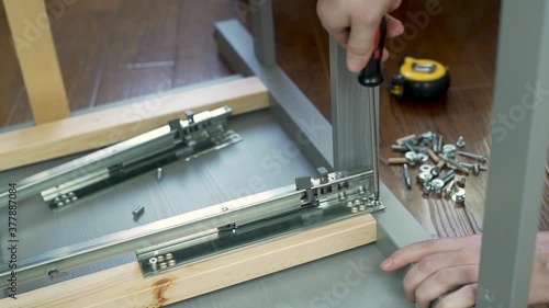 Wallpaper Mural Male Master Furniture Assembler Twists the Screw with a Screwdriver, Close-up. The Employee Is Engaged In Assembling Furniture. Torontodigital.ca