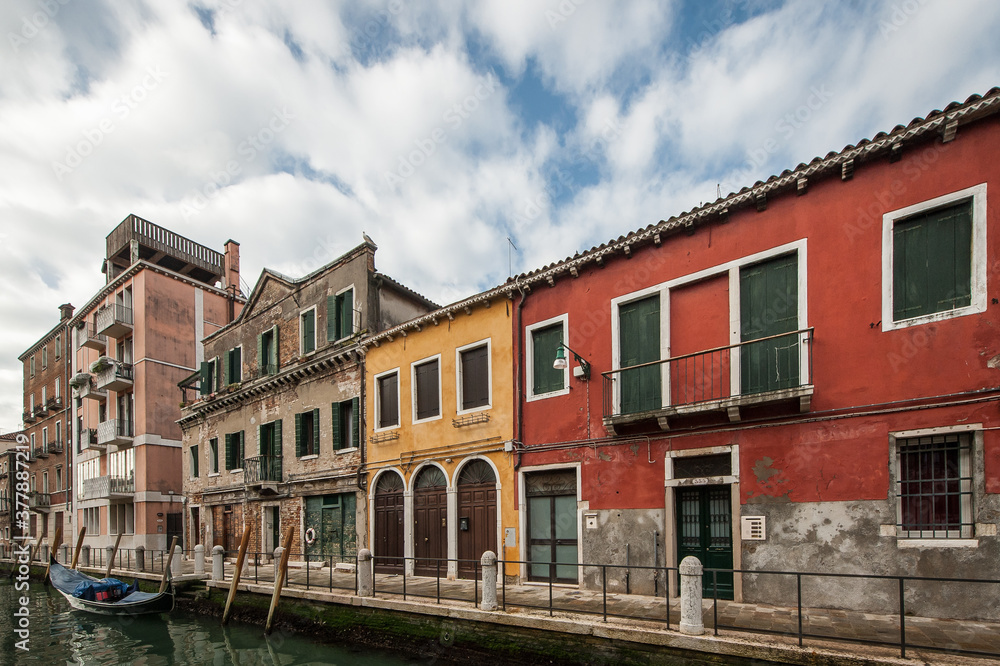 Streets of Venice with a typical waterl canal during a cloudy day, Italy