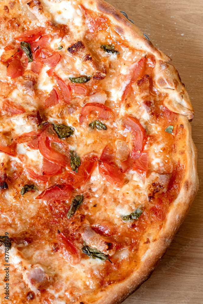 Homemade pizza with cheese and tomatoes on thin crust. Do it yourself pizza with pasta. Vertical photo. Homemade pizza with cheese and tomatoes on thin crust. Do it yourself pizza with pasta. Vertical photo.