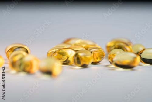 Couple golden Omega 3 fatty acids capsules 