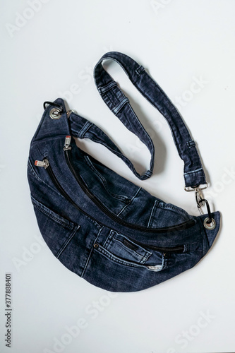 Denim belt bag for men and women on white background. Vertical photo.
