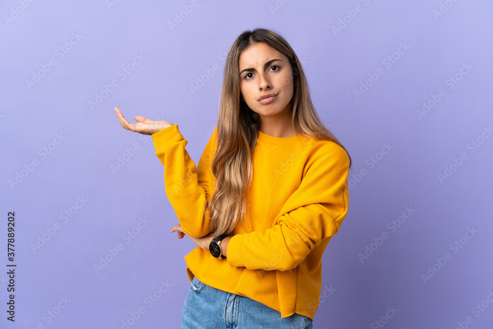Young hispanic woman over isolated purple background having doubts Young hispanic woman over isolated purple background having doubts