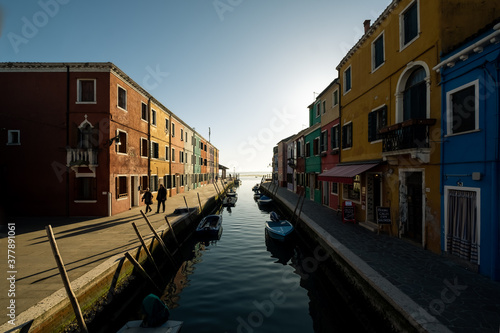The view of colorful houses alongside the water canal on the Burano island during a sunset, Veneto, Italy © Ivana Tačíková