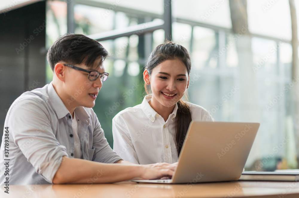 Asian business people man and woman conference talking and working with laptop together. Young couple work at home. Asian business people man and woman conference talking and working with laptop together. Young couple work at home.