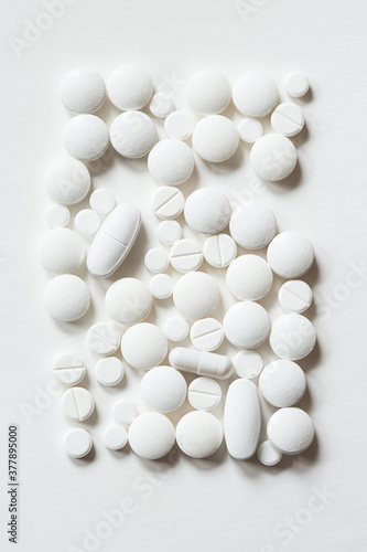 tablets of various shapes on white background close up top view. minimalistic concept of medicine and treatment. rectangle shape
