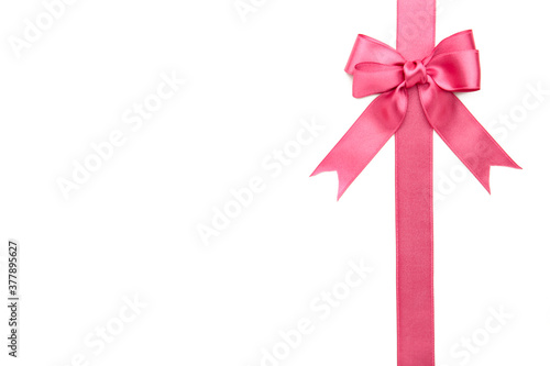Pink ribbon with bow isolated on a white background.