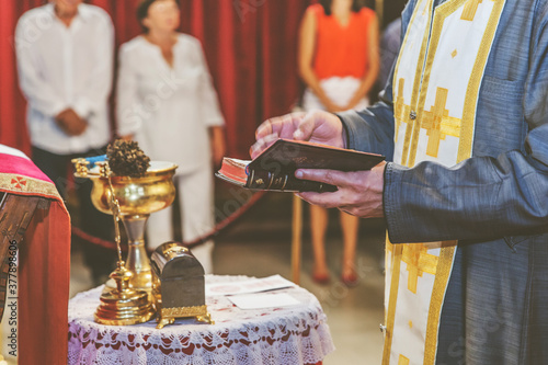 orthodox priest holds a golden cross in an orthodox church during a religious ceremony