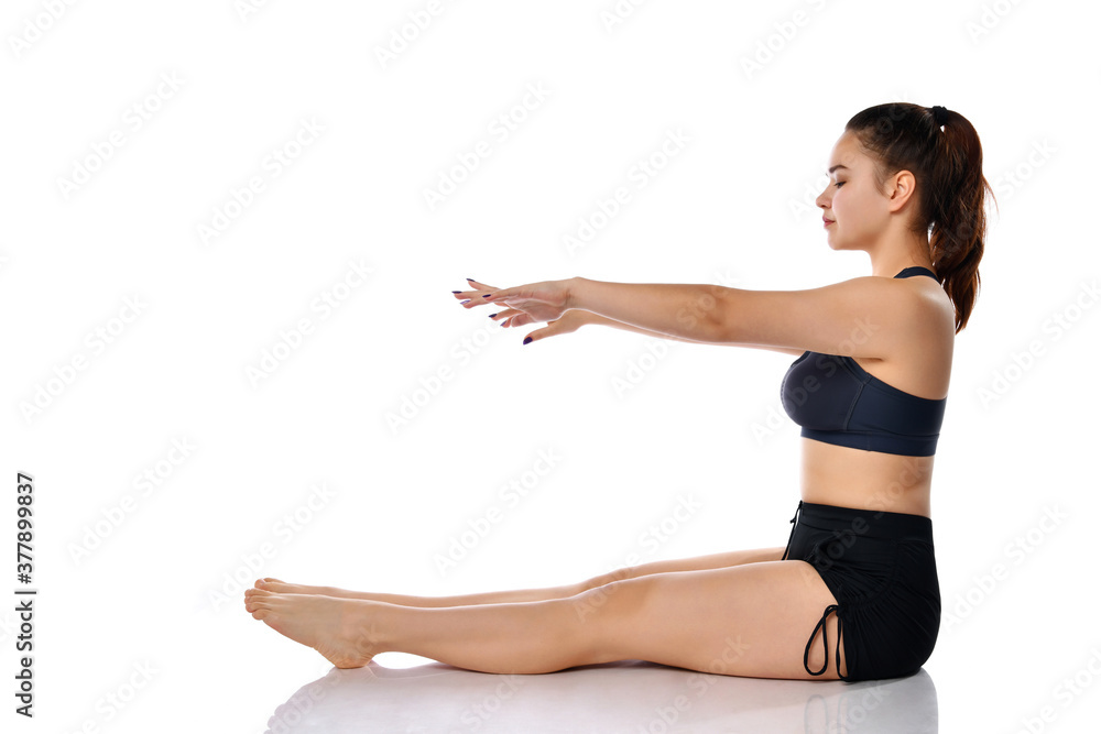 Woman stretching sit on floor studio shot on white Woman stretching sit on floor studio shot on white