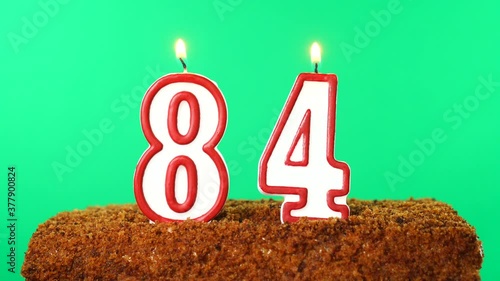 Cake with the number 84 lighted candle. Chroma key. Green Screen. Isolated