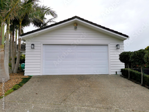 фотографія Modern white garage door separate from the house
