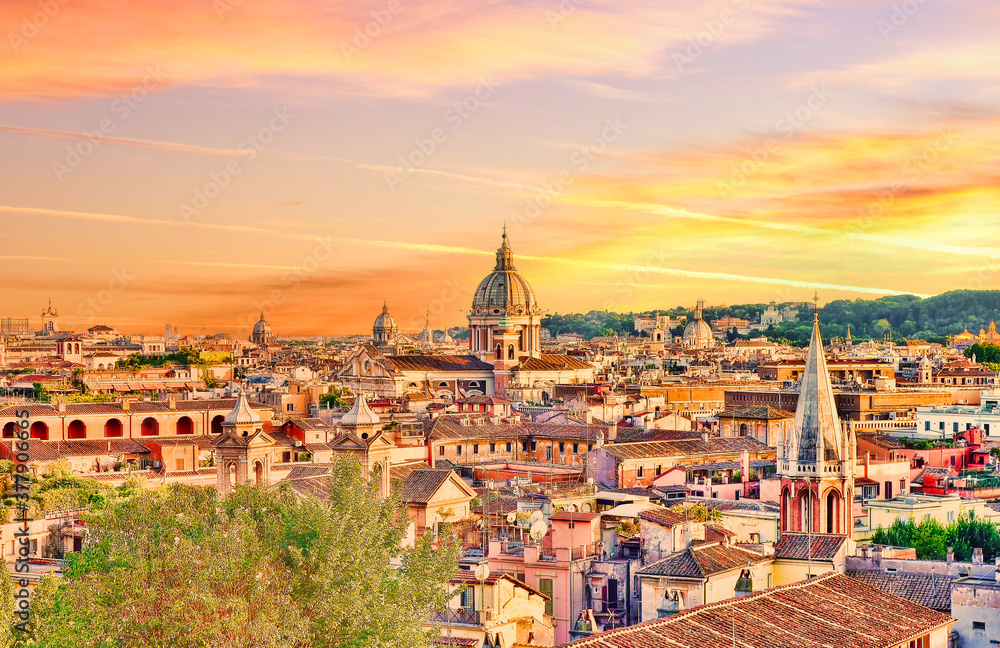 Rome skyline at sunset. Rome, Italy, cityscape or landscape at sunset with a prevalent yellow orange tint kindly provided by the setting sun. Rooftops, monuments and church domes