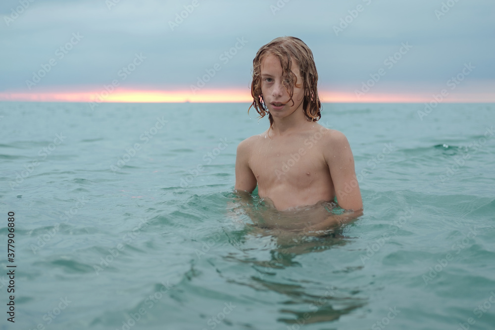 Young teenage boy enjoys the sea at the beach.