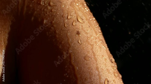 Wet body. Water droplets run down the female body. To wash in the shower delicate skin photo