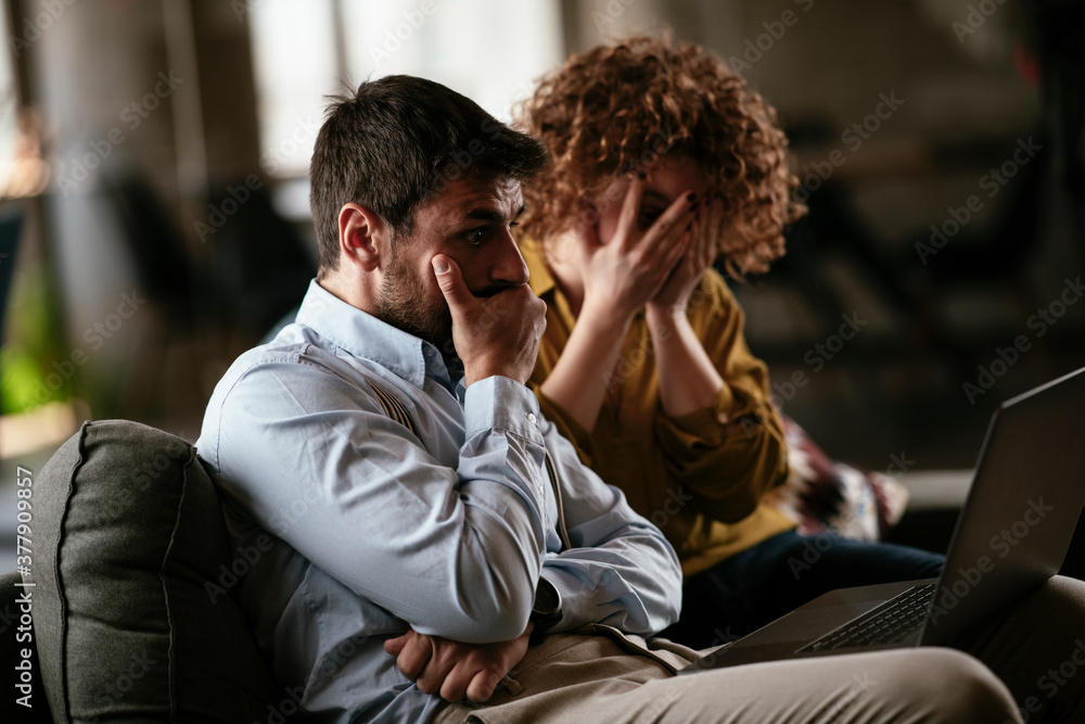 Colleagues sitting and talkig in office. Businesswoman and businessman discussing work in office... Colleagues sitting and talkig in office. Businesswoman and businessman discussing work in office...