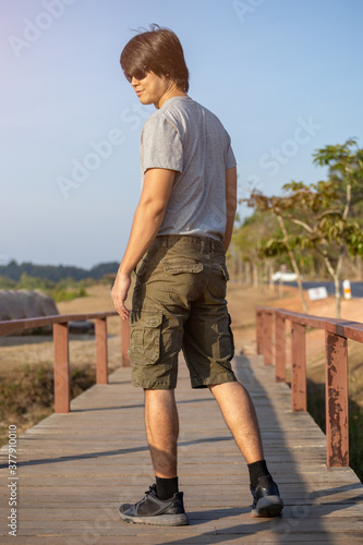 Fototapeta Naklejka Na Ścianę i Meble -  Asia man in bermuda shorts and t-shirt, outdoor activity concept