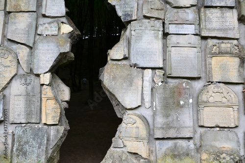 Kazimierz Dolny, Poland. Jewish cemetery with a cracked wailing wall in Czerniawy. The lapidarium, lined with a fragments of historic matzevot, referes to Jerusalem Wailing Wall photo