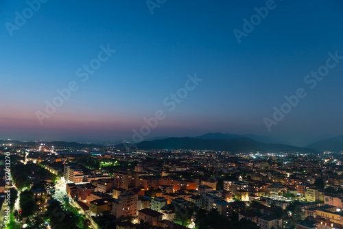 Fototapeta Naklejka Na Ścianę i Meble -  Panorama of the top view of the city in the evening just after sunset. Brescia seen from the castle at night timelapse.