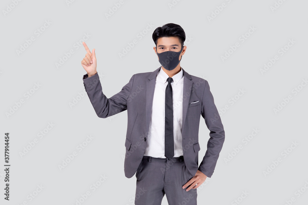 Portrait young asian businessman in suit wearing face mask for protective covid-19 isolated on white background, business man presenting and showing, quarantine for pandemic coronavirus, new normal. Portrait young asian businessman in suit wearing face mask for protective covid-19 isolated on white background, business man presenting and showing, quarantine for pandemic coronavirus, new normal.
