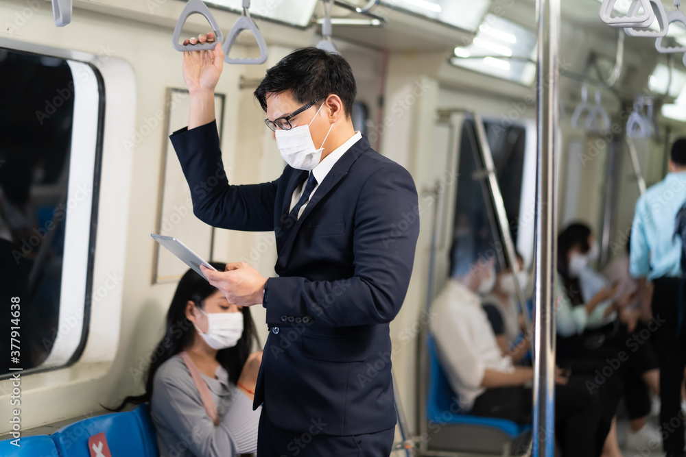Asian young business man Passengers On public transport. Face Mask protection against virus. Covid-19, coronavirus pandemic Asian young business man Passengers On public transport. Face Mask protection against virus. Covid-19, coronavirus pandemic