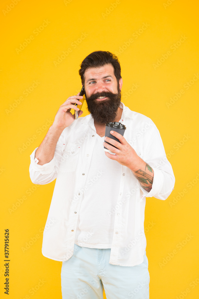 cheerful guy with moustache and beard drink coffee and talking on smartphone, communication cheerful guy with moustache and beard drink coffee and talking on smartphone, communication