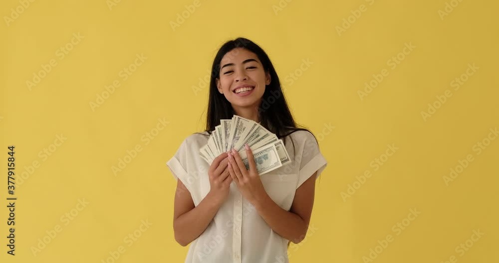 Rich korean woman waving fan of cash dollar bills in her hand Rich korean woman waving fan of cash dollar bills in her hand