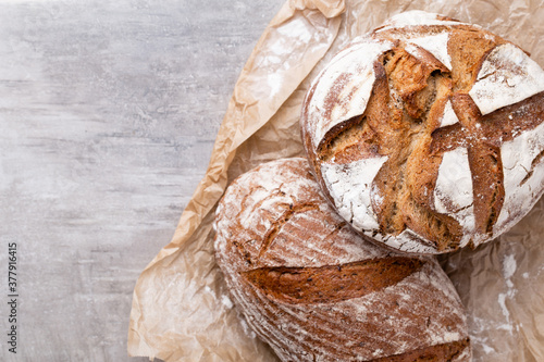 Assortment of baked bread on wooden table background. photo