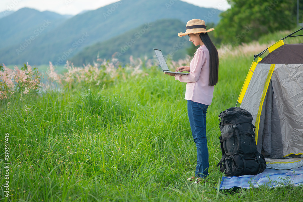 Portrait of successful woman with laptop near camp tent outdoors. Portrait of successful woman with laptop near camp tent outdoors.