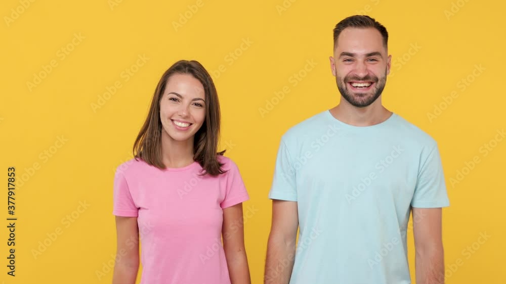 Young fun couple friends bearded man woman 20 in casual clothes posing isolated on yellow background studio. People emotions lifestyle concept Meeting together greeting holding hands handshake gesture Young fun couple friends bearded man woman 20 in casual clothes posing isolated on yellow background studio. People emotions lifestyle concept Meeting together greeting holding hands handshake gesture