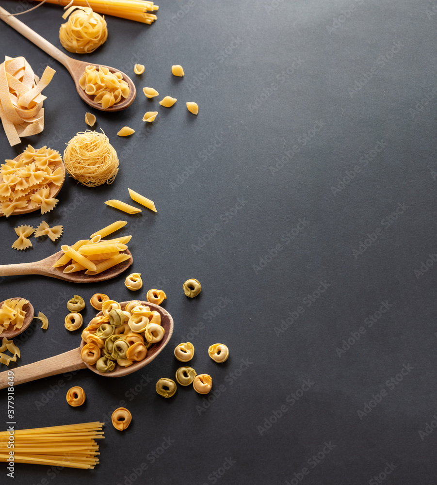 Pasta assortment on black background, top view. Cooking italian cuisine concept Pasta assortment on black background, top view. Cooking italian cuisine concept