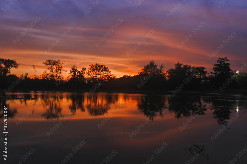Naklejka premium sunset over the river