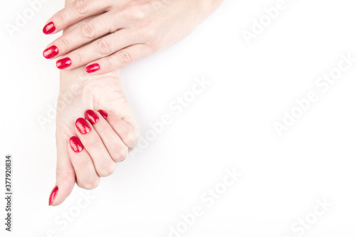 Woman's hands with nail red manicure isolated on white background, close up view. Classic red manicure, concept of beauty salon