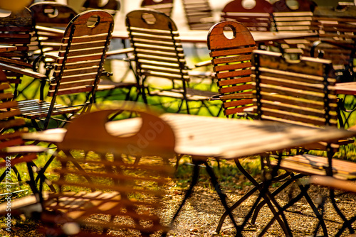 empty chairs and desks of a garden restaurant