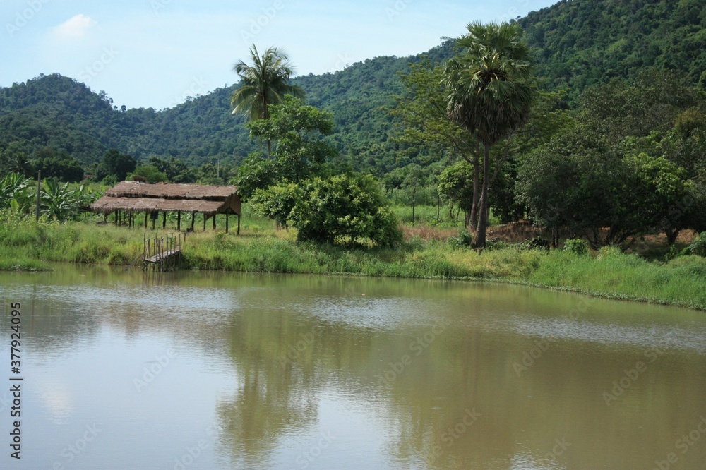 Beautiful view of the green field with water lack hill and houses Beautiful view of the green field with water lack hill and houses