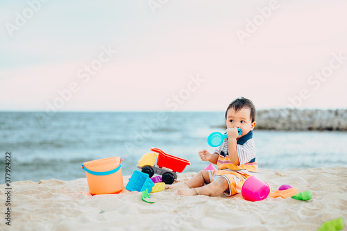 Wallpaper Mural Baby boy playing with beach toys with his mother on tropical beach.Summer family vacation Torontodigital.ca