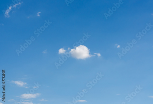 one single small white cloud isolated on blue sky background